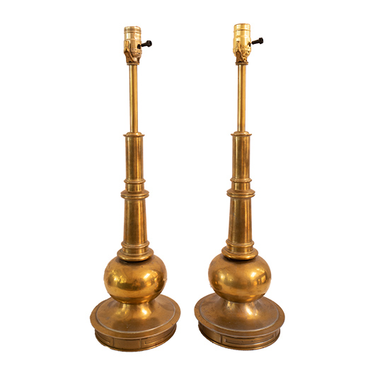A pair of solid brass table lamps by Stiffel on a circular brass base plate. The bulbous form ascending from the base tapers to meet the bulb.